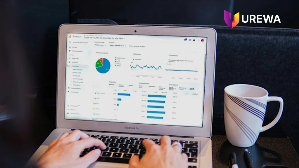 An analyst reviewing supply chain analytics on a laptop — acquisition, behaviour and conversion style dashboards used to monitor operational performance rather than compile spreadsheets